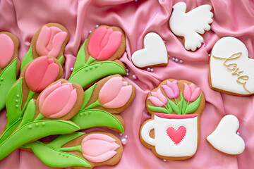 background banner greeting card for international women day tulips cup and pigeon shape gingerbread cookies on silk fabric background