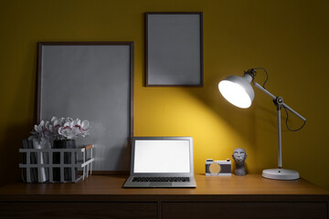 Modern workplace with laptop and glowing lamp in dark office