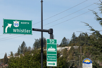 Highway 99 north to Whistler and ferry to Nanaimo and Gibsons signs seen during a sunny winter afternoon, Vancouver, British Columbia, Canada - obrazy, fototapety, plakaty