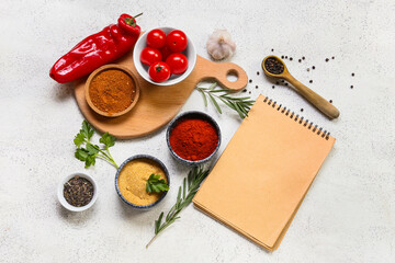 Composition with spices, vegetables and blank notebook on light background