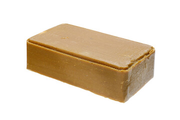 Piece of craft soap, brown in color. On a white background, close-up