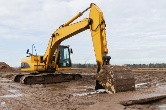 Heavy excavators at a construction site. Construction equipment for earthworks. Quarry excavator. Improvement of the territory and earthworks.