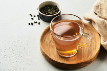 Ginger tea. Cup of ginger tea with lemon, honey and mint on grey background. Concept alternative...
