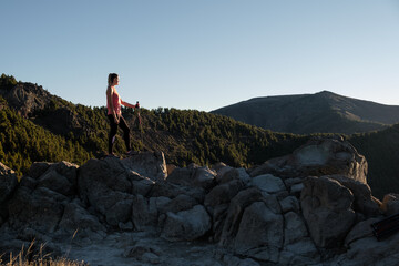 Woman hiking with copy space at sunset