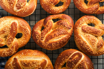 Bavarian pretzels. Oktoberfest food menu, traditional salted pretzels over old dark wooden background. Top view with space for text. Oktoberfest theme