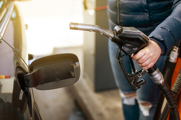 Process of refueling a car fill with petrol fuel at the gas station, pump filling fuel nozzle in...