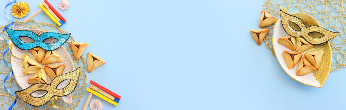 Purim celebration concept (jewish carnival holiday) over blue background. Top view, flat lay