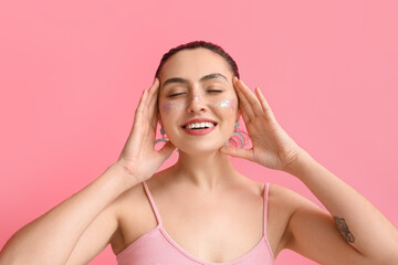 Fototapeta premium Smiling woman with creative makeup and closed eyes on pink background