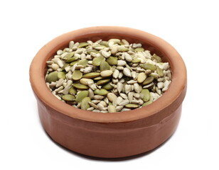 Mix seed, pumpkin seeds, sunflower seeds and pine nuts in clay pot isolated on white