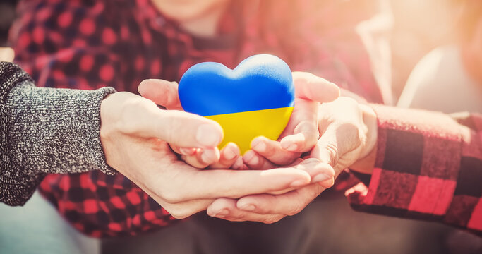 Hands holding a heart in Ukrainian colours