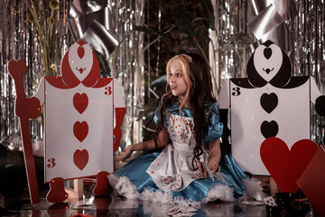 girl in the role of alice in wonderland in a blue dress