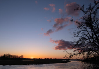 clear sky, golden sunset, winding river, spring evening near Lielupe river Latvia 