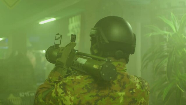 Private Military Company operator shoots from an RPG rocket launcher . Soldier with antitank grenade launcher . R. P. G. shooter shooting . Shot on ARRI movie camera in Slow Motion .