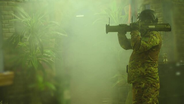 Private Military Company operator shoots from an RPG rocket launcher . Soldier with antitank grenade launcher . R. P. G. shooter shooting . Shot on ARRI movie camera in Slow Motion .