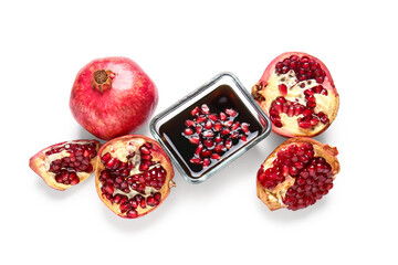 Bowl of pomegranate molasses and fresh fruits on white background