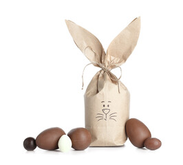 Easter bunny gift bag and chocolate eggs isolated on white background