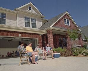 Group of male middle aged Friends hanging out in driveway, tailgating from home 