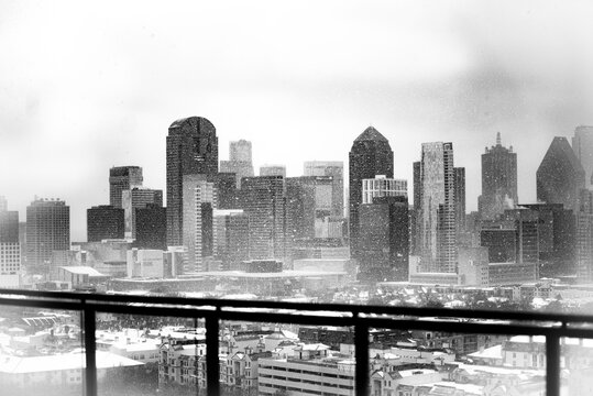 A Black and White Image of The Dallas Skyline During a Snow Storm 