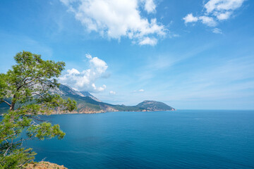 Obraz premium The Bay of Adrasan extends along more than 2.5 km of Antalya, naturally protected area, surrounded by a national park with pine forests, Taurus Mountains, blue water lagoons and sandy beaches.