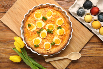 Tasty Easter tart, painted eggs and tulip flowers on wooden background