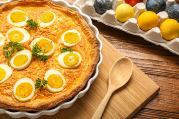 Tasty Easter tart with eggs on wooden table, closeup