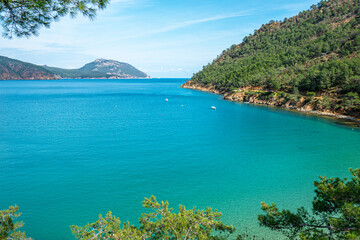 The Bay of Adrasan extends along more than 2.5 km of Antalya, naturally protected area, surrounded by a national park with pine forests, Taurus Mountains, blue water lagoons and sandy beaches.