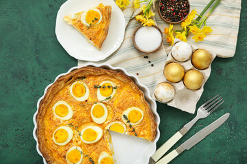 Composition with tasty Easter tart, painted eggs, spices and flowers on color background