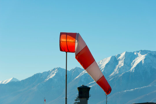 Windsock with Snow-capped Mountain in Locarno, Switzerland.