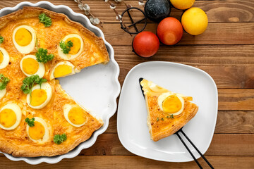 Delicious Easter tart with painted eggs on wooden background