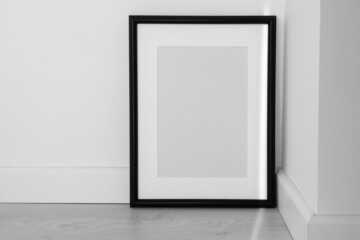 Minimalist black frame mockup on white background with shadow in interior