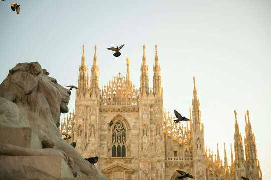 Milan Cathedral and Lion Statue with Sunlight in Lombardy, Italy.