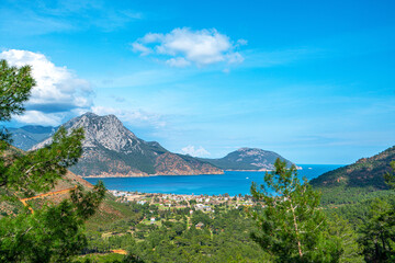 Naklejka na ściany i meble The Bay of Adrasan extends along more than 2.5 km of Antalya, naturally protected area, surrounded by a national park with pine forests, Taurus Mountains, blue water lagoons and sandy beaches.