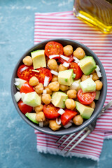 Healthy chickpea salad with cherry tomato, avocado and cucumber