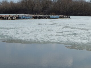 Frozen pontoon on the river. The boat dock was frozen in winter. - 490390428