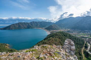 The Scenic view of  Bay of Adrasan from the Adrasan Castle, naturally protected area, surrounded by a national park with pine forests, Taurus Mountains, blue water lagoons and sandy beaches.