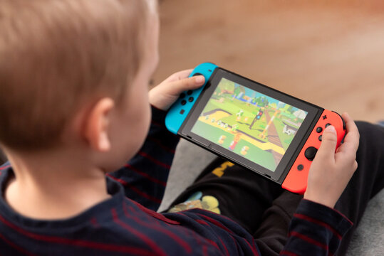 Boy plays Nintendo Switch console