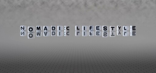 nomadic lifestyle word or concept represented by black and white letter cubes on a grey horizon background stretching to infinity
