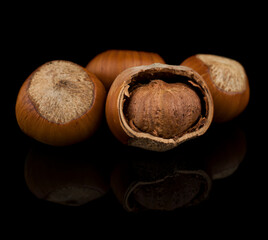 hazelnut fruits, hazelnuts on a black background with reflection