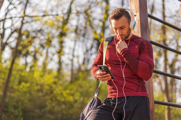 Man using smart phone after outdoor workout