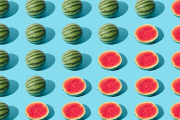 Arranged watermelon and the half on a blue pastel background. Minimal pattern and design.