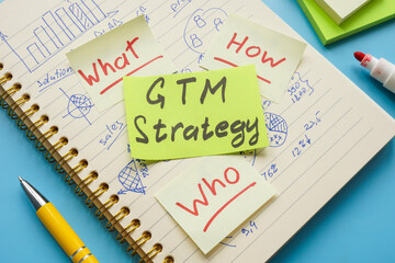 Notepad with marks and sticker GTM strategy.