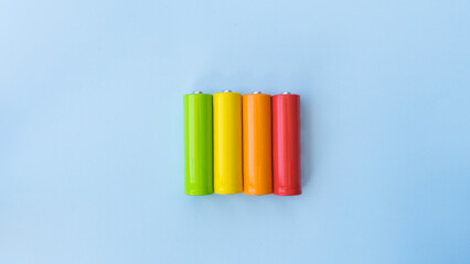 Multicolored batteries in the colors of the energy saving concept
