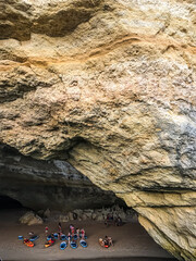 people silhouettes in the cave preparing to swim on sup boards. travel adventure and sports...