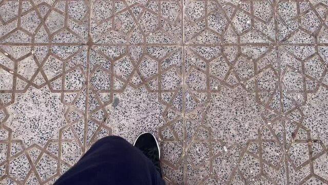 Real-time footage of a man walking with sport shoes outdoor