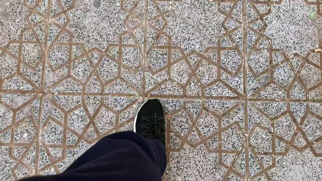 Slow-motion footage of a man walking with sport shoes outdoor