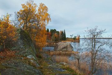 Fototapeta na wymiar Rocky landscape Monrepos park near Vyborg on shore of bay in autumn.