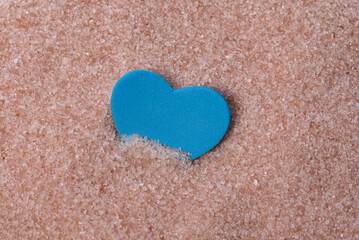 Blue heart in the sand. Romantic concept. 