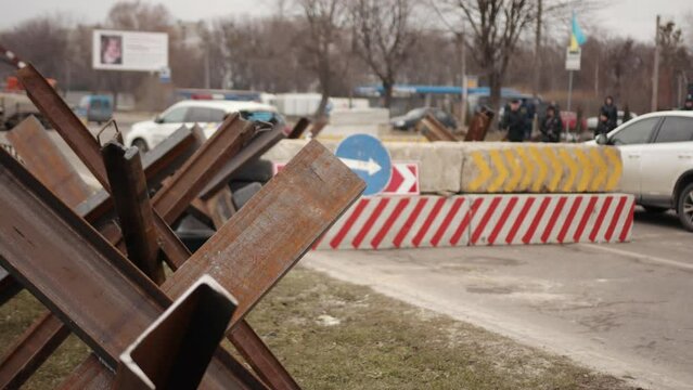 Checkpoint of ukrainian military on roads of ukraine equipment device, sandbags. Control sign and concrete blocks at entrance to the ukrainian checkpoint from russia. Car traffic