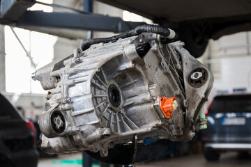 An electric car engine with a gearbox removed from a car for repair. IPM-SynRM (Internal Permanent...