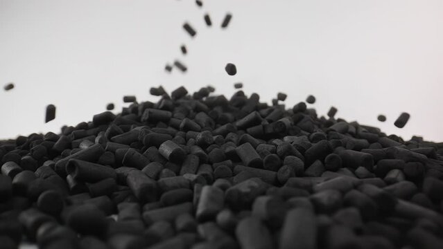 Slow Motion Macro of Black Sorbent Particles Falls